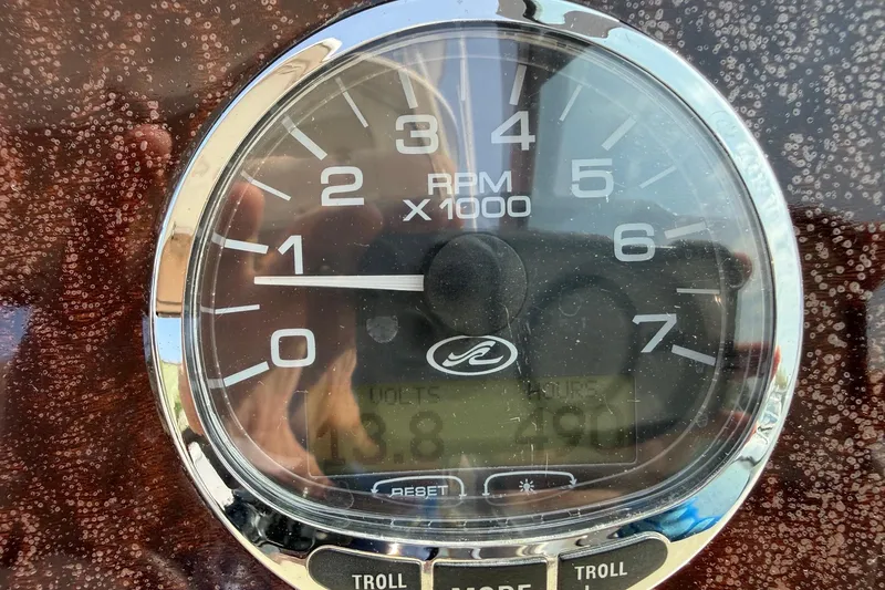 Slide: The Image of Close-up of a 2007 Sea Ray Sundancer 310 tachometer displaying RPM and engine hours. - 23