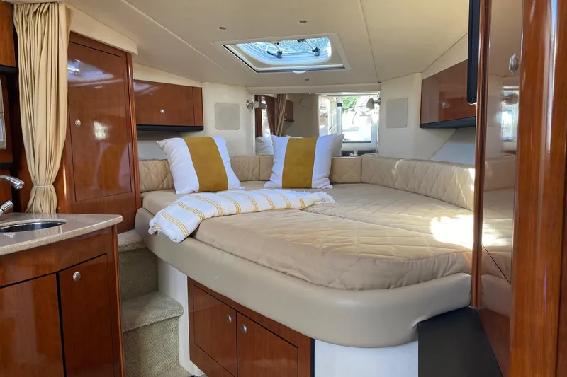 Slide: The Image of Luxurious 2007 Sea Ray Sundancer 310 cabin interior with cozy bed and elegant wood finishes. - 39