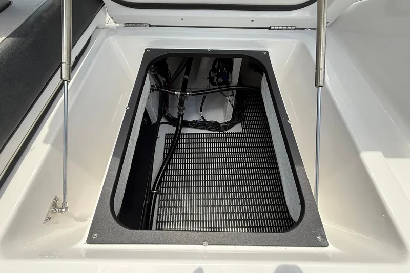 Slide: The Image of Storage compartment of 2027 Monterey Elite 30 OB boat, featuring hydraulic lift supports. - 20