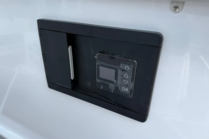 Slide: The Image of Control panel on a 2027 Monterey Elite 30 OB boat, featuring a sleek black design. - 17