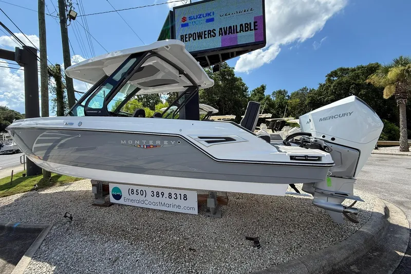 Slide: The Image of 2027 Monterey Elite 30 OB boat displayed outdoors with Mercury engine. - 1
