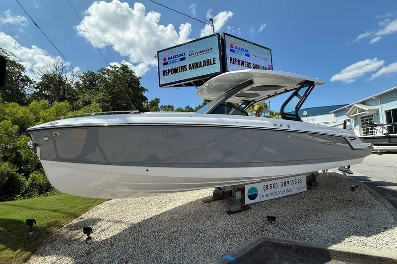 The Image of 2027 Monterey Elite 30 OB boat displayed outdoors under a clear sky. - 0