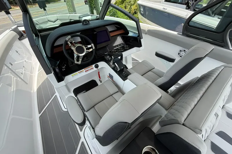 Slide: The Image of Interior of 2027 Monterey Elite 30 OB boat with modern steering and seating. - 9