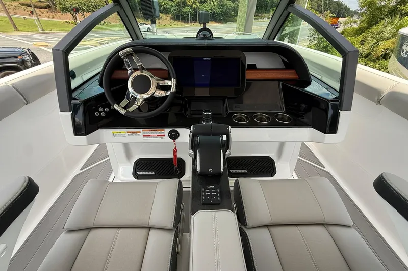 Slide: The Image of Cockpit of 2027 Monterey Elite 30 OB boat with modern steering and dashboard controls. - 10
