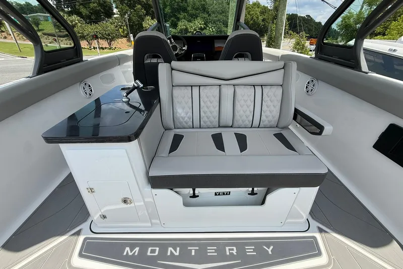 Slide: The Image of 2027 Monterey Elite 30 OB boat interior with luxurious seating and sleek design. - 11