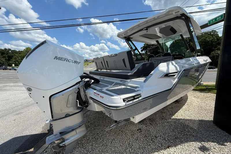 Slide: The Image of 2027 Monterey Elite 30 OB boat with Mercury outboard engine, parked on gravel under a blue sky. - 3