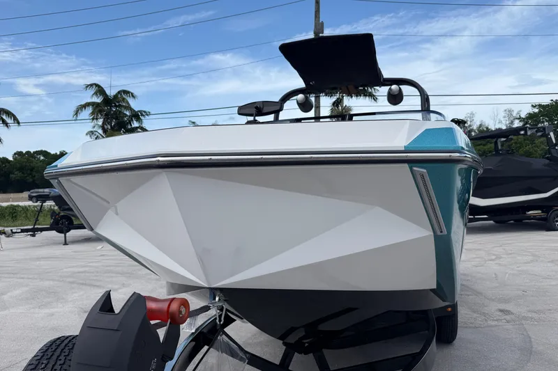 Slide: The Image of 2021 Nautique Super Air Nautique G25 Coastal Edition boat on trailer, front view. - 15