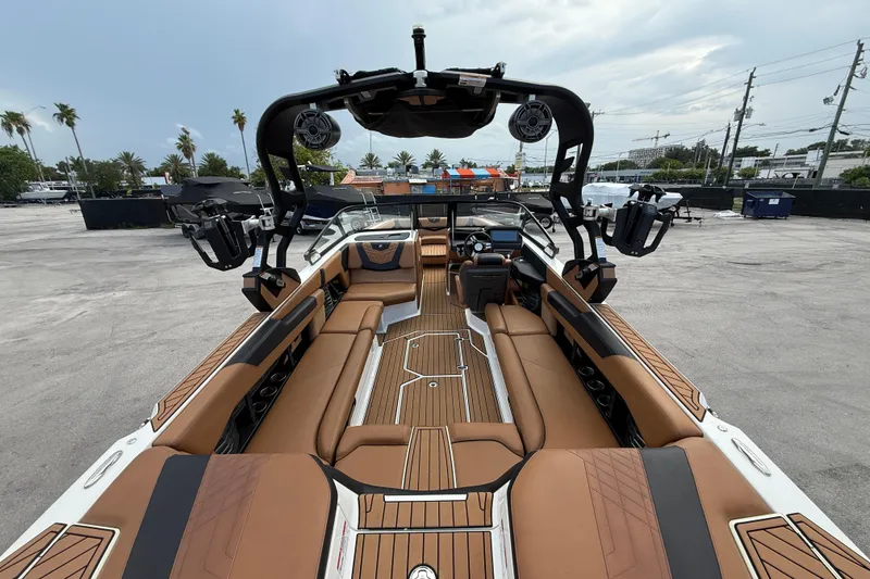 Slide: The Image of 2021 Nautique Super Air Nautique G25 Coastal Edition interior with luxurious seating and advanced controls. - 8