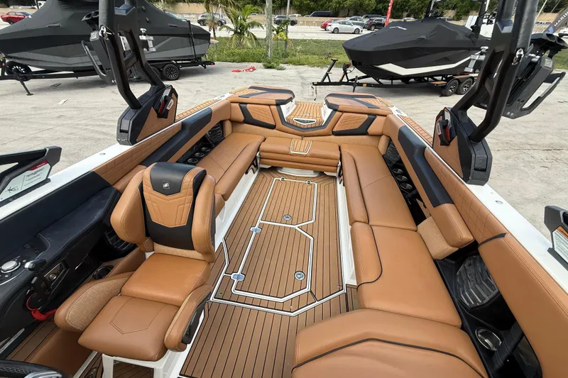 Slide: The Image of 2021 Nautique Super Air Nautique G25 Coastal Edition interior with tan leather seating and sleek design. - 4