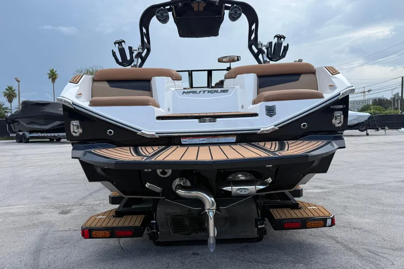 Slide: The Image of 2021 Nautique Super Air Nautique G25 Coastal Edition boat rear view with teak deck. - 13
