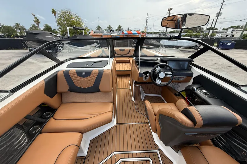 Slide: The Image of 2021 Nautique Super Air Nautique G25 Coastal Edition interior with luxurious seating and modern dashboard. - 6
