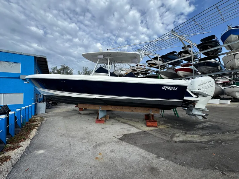 Slide: The Image of A 2004 Intrepid 370 Center Console boat is on a dry dock. - 5