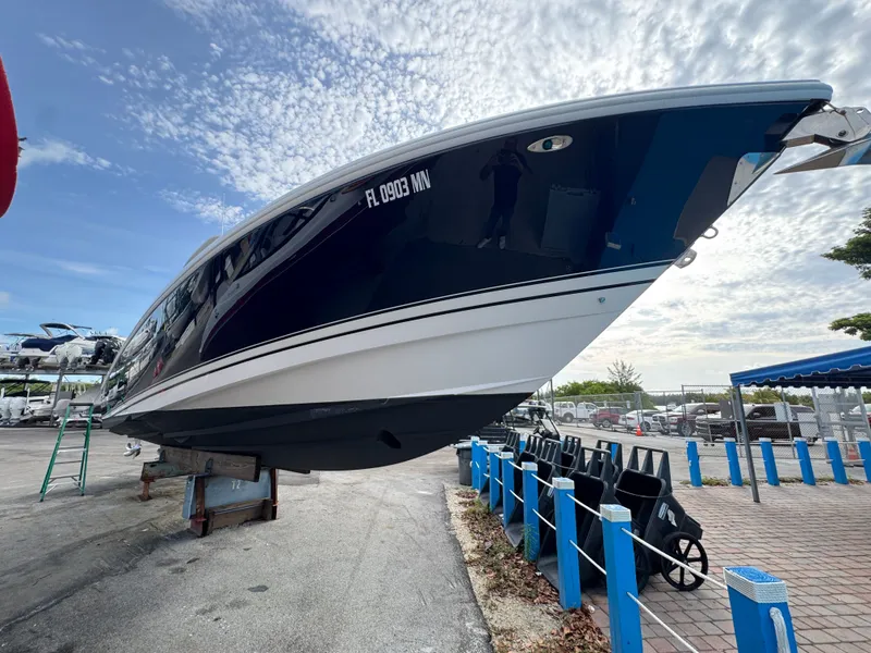 Slide: The Image of A 2004 Intrepid 370 Center Console boat is on a dry dock under a cloudy sky. - 6