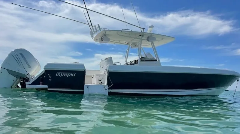 The Image of A 2004 Intrepid 370 Center Console boat on calm water with a clear sky. - 0