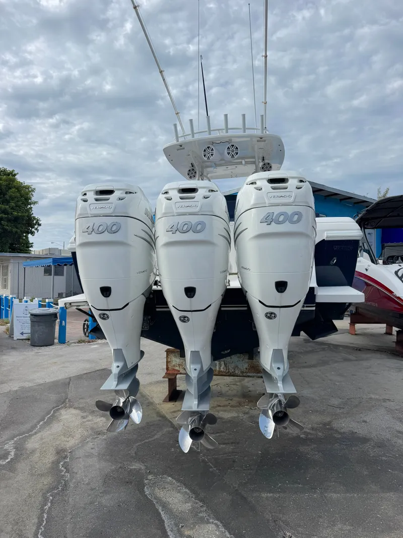 Slide: The Image of Three powerful outboard engines are mounted on the stern of a boat in a dry dock. - 8