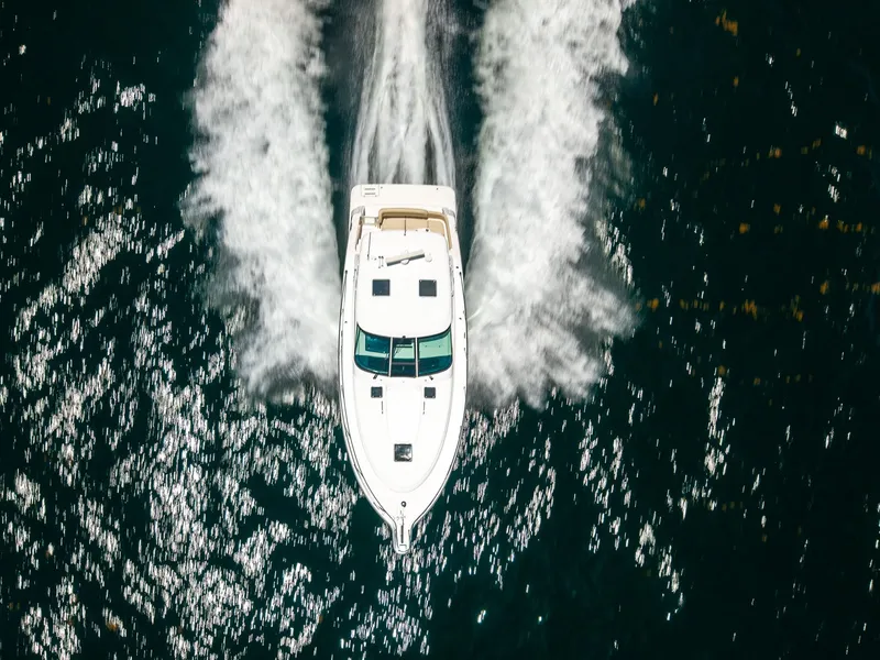Slide: The Image of Aerial view of a 2008 Tiara Yachts 4300 Sovran speeding across the water. - 6