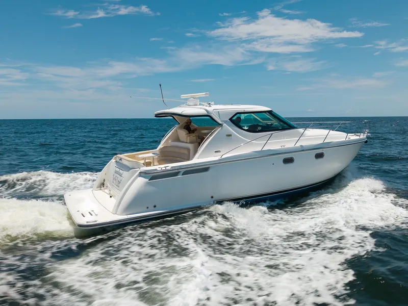 The Image of A 2008 Tiara Yachts 4300 Sovran cruising on open water under a blue sky. - 0