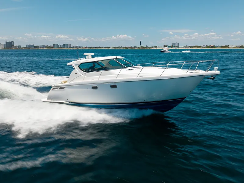 Slide: The Image of A 2008 Tiara Yachts 4300 Sovran cruising swiftly over blue water. - 7