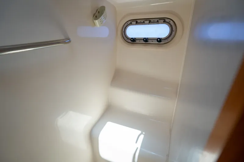 Slide: The Image of Interior of the 2008 Tiara Yachts 4300 Sovran with porthole and seating area. - 23