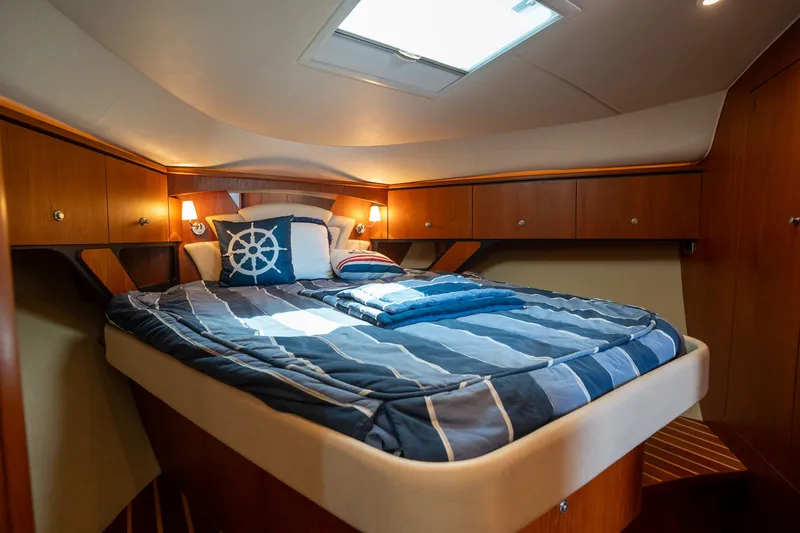 Slide: The Image of Cabin of the 2008 Tiara Yachts 4300 Sovran with a cozy bed and nautical decor. - 21