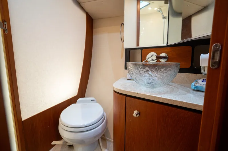 Slide: The Image of Interior view of a yacht bathroom with a sink and toilet. - 22