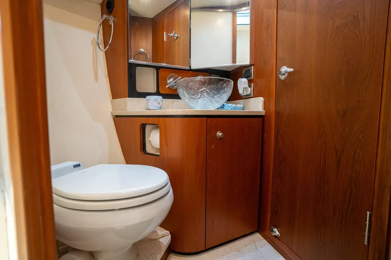 Slide: The Image of The image shows a yacht bathroom with wooden cabinetry and a modern glass sink. - 34