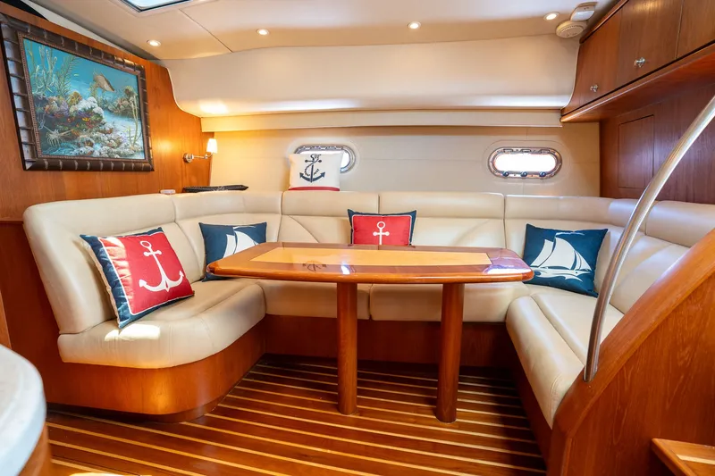 Slide: The Image of Interior of the 2008 Tiara Yachts 4300 Sovran with elegant seating area and nautical-themed cushions. - 26