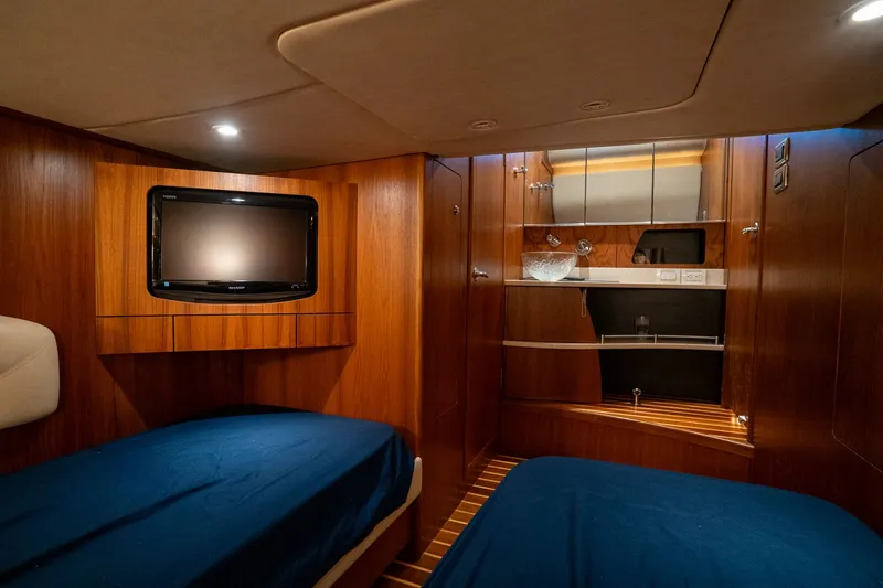 Slide: The Image of Interior of a 2008 Tiara Yachts 4300 Sovran with wood paneling and two beds. - 33