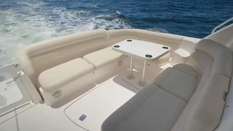 Slide: The Image of Tiara Yachts 4300 Sovran 2008 with beige seating area and table on the water. - 18