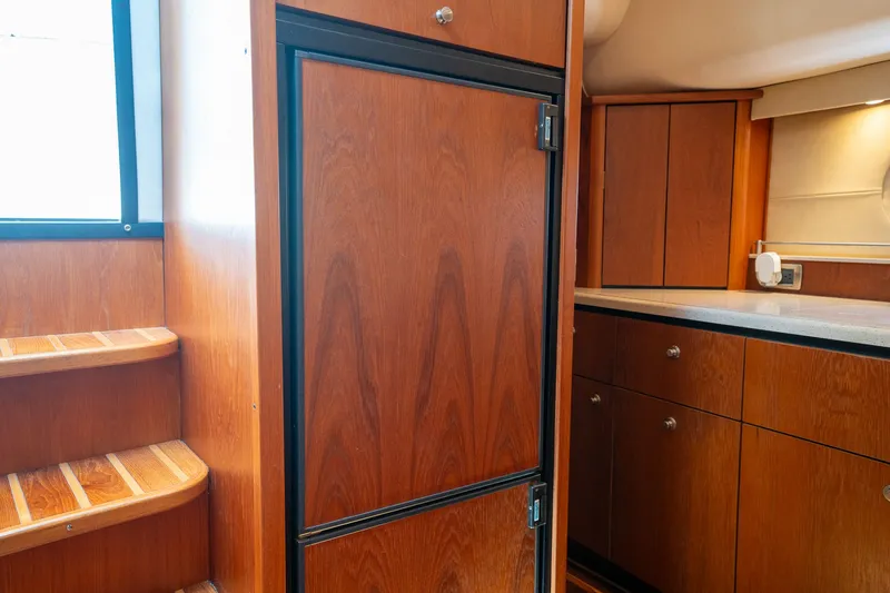 Slide: The Image of Interior of the 2008 Tiara Yachts 4300 Sovran with wooden cabinets and stairs. - 28