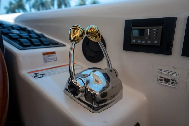 Slide: The Image of Close-up of the control console on a 2008 Tiara Yachts 4300 Sovran, featuring throttle levers. - 16