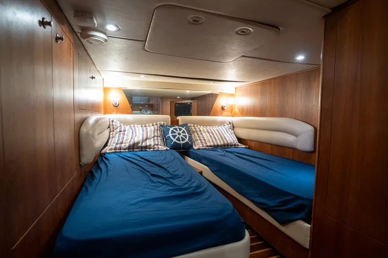 Slide: The Image of The 2008 Tiara Yachts 4300 Sovran cabin features two single beds with blue covers. - 31