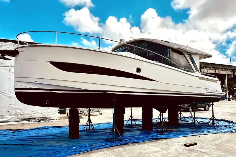 Slide: The Image of 2021 Greenline 39 Hybrid yacht on stands, showcasing sleek design under a blue sky. - 32