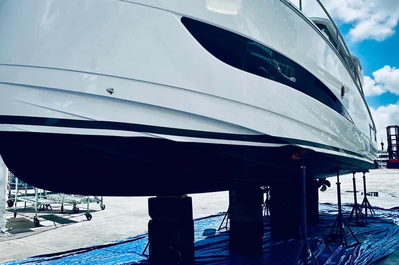 Slide: The Image of 2021 Greenline 39 Hybrid yacht on stands, showcasing sleek design under a blue sky. - 33