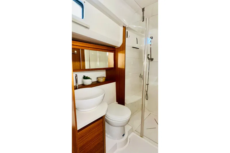 Slide: The Image of Modern bathroom in 2021 Greenline 39 Hybrid yacht with wood accents and glass shower. - 28