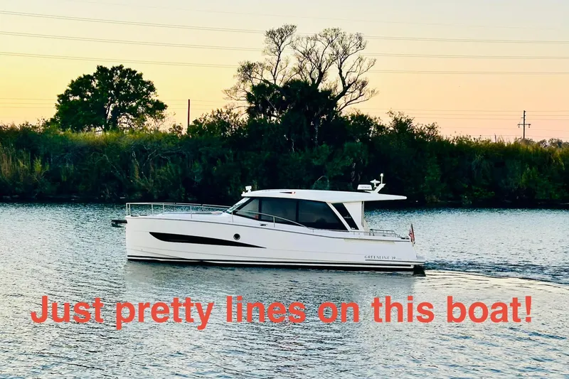 The Image of 2021 Greenline 39 Hybrid boat cruising on a serene river at sunset. - 0