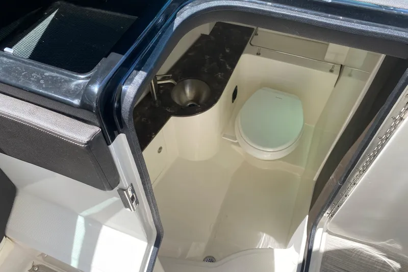 Slide: The Image of Interior view of 2018 Sea Ray SLX 350 boat bathroom with toilet and sink. - 21