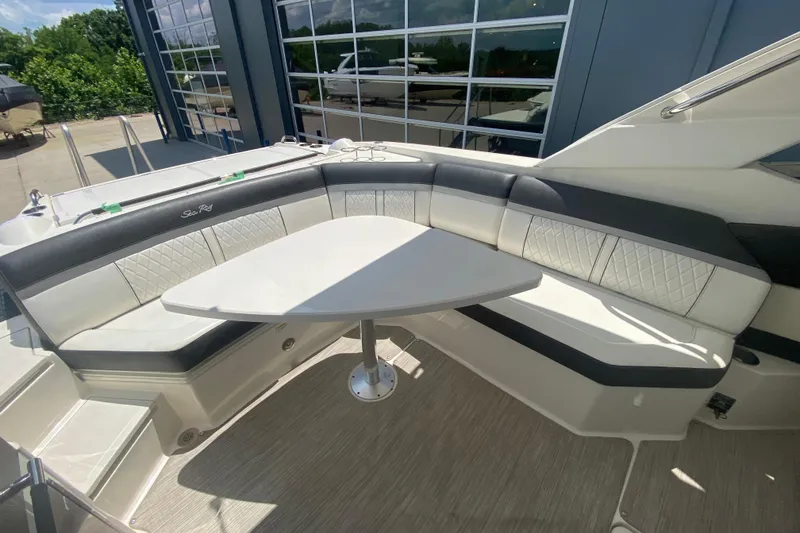 Slide: The Image of 2018 Sea Ray SLX 350 boat interior with elegant seating and a central table. - 14