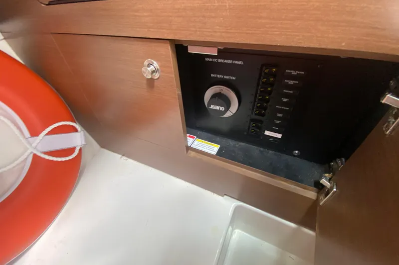 Slide: The Image of 2018 Sea Ray SLX 350 boat interior showing main DC breaker panel and battery switch. - 32