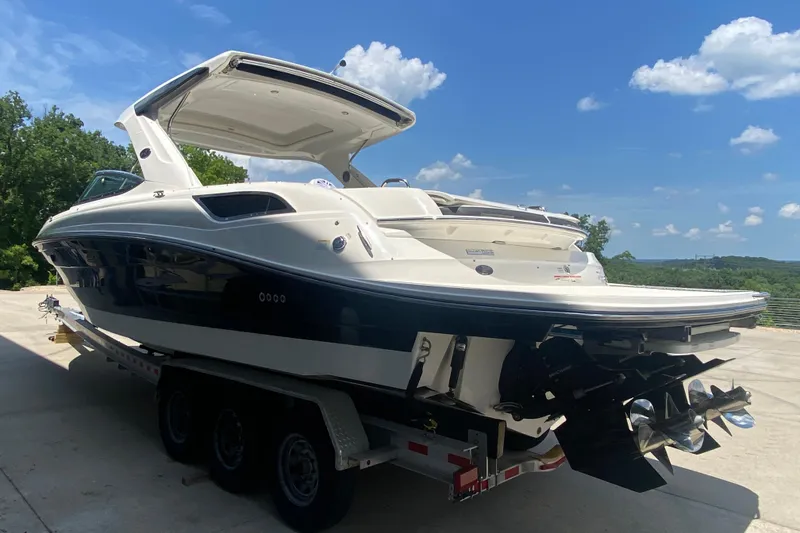 Slide: The Image of 2018 Sea Ray SLX 350 boat on trailer under clear blue sky. - 5
