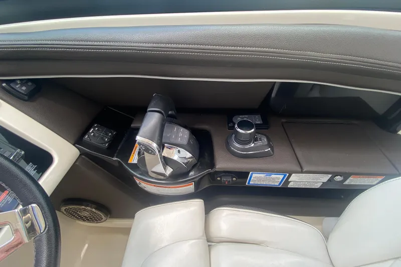 Slide: The Image of 2018 Sea Ray SLX 350 boat cockpit controls with joystick and throttle levers. - 25