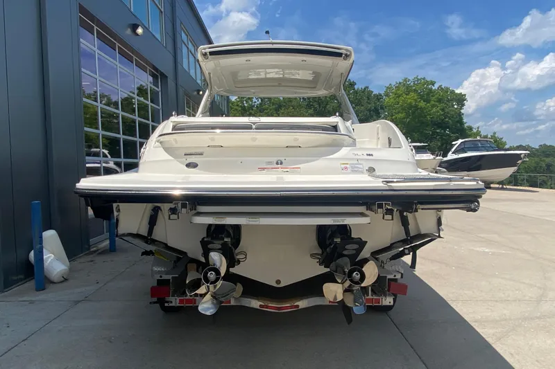 Slide: The Image of 2018 Sea Ray SLX 350 boat, rear view, docked outdoors on a sunny day. - 4