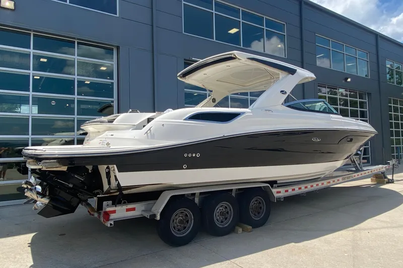 Slide: The Image of 2018 Sea Ray SLX 350 boat on trailer, parked outside a modern building. - 3