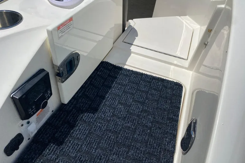 Slide: The Image of Interior view of a 2018 Sea Ray SLX 350 boat with carpeted flooring. - 12
