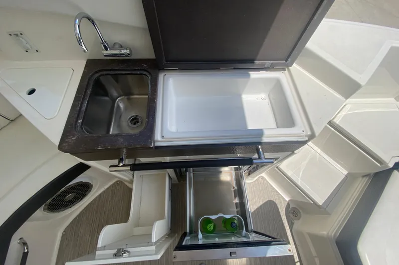 Slide: The Image of 2018 Sea Ray SLX 350 boat kitchenette with sink, cooler, and storage drawers. - 16