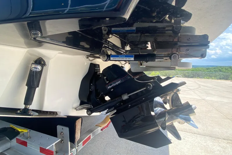 Slide: The Image of 2018 Sea Ray SLX 350 boat stern with MerCruiser engine and propeller, parked on trailer. - 7