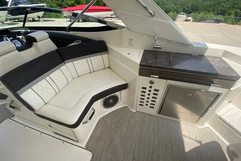 Slide: The Image of 2018 Sea Ray SLX 350 boat interior with seating and kitchenette area. - 17