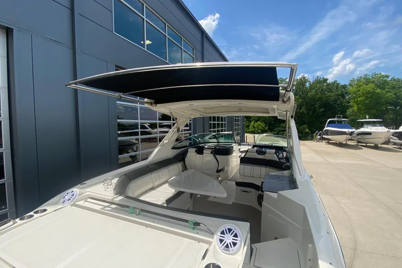 Slide: The Image of 2018 Sea Ray SLX 350 boat with spacious seating and modern design, docked outdoors. - 42