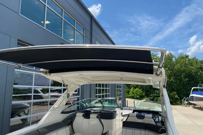 Slide: The Image of 2018 Sea Ray SLX 350 boat with sleek design, docked near a modern building. - 41