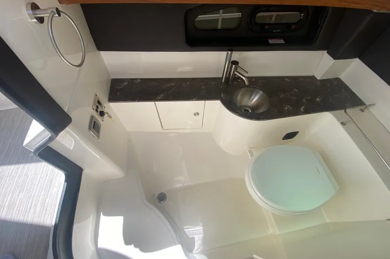 Slide: The Image of 2018 Sea Ray SLX 350 boat bathroom with sink, toilet, and countertop. - 22